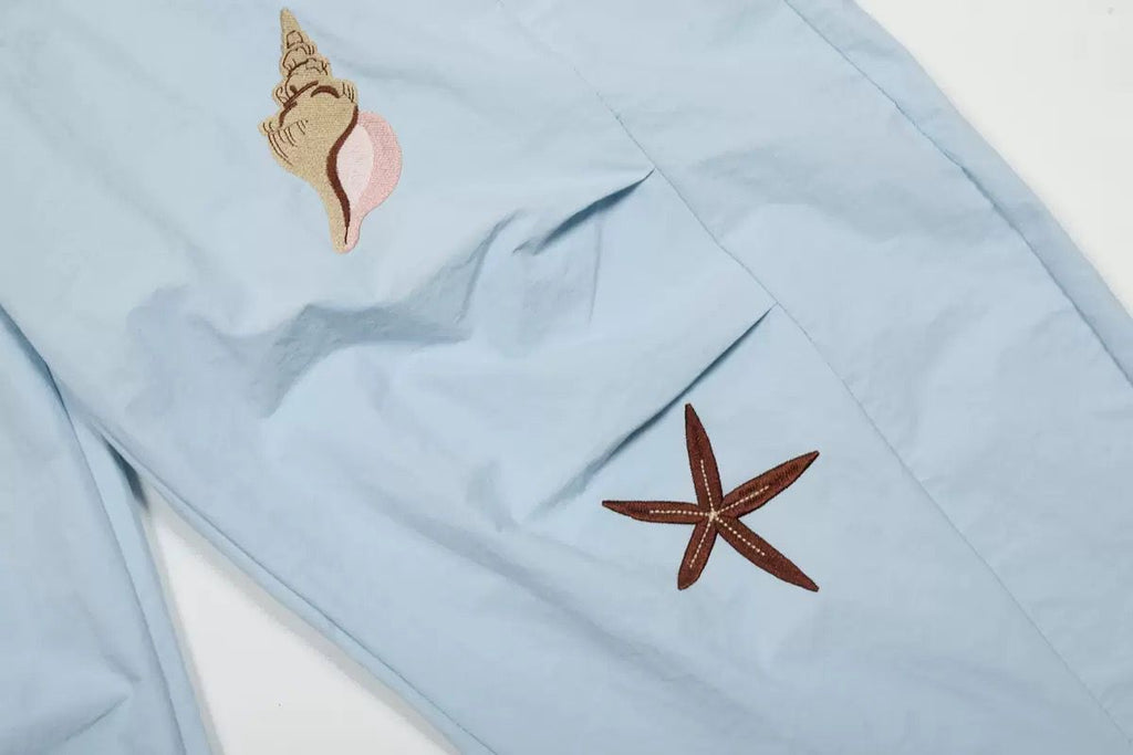 Embroidered shell print pants